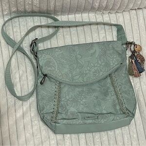 Sakroot Foldover Crossbody. Light Sage Green in color. Zipper foldover pocket.